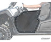 SuperATV aluminum door closed on a Yamaha Viking with the driver resting an arm on the top rail, side view