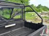 Rear cargo bed view of the Polaris Ranger showing the SuperATV rear roll cage support bars behind the rear window