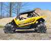 Yellow Yamaha YXZ with SuperATV heavy duty nerf bars and mud tires, side view at a dirt mound