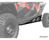 SuperATV nerf bar installed on a red Polaris RZR XP, close-up along the rocker between the front and rear wheels