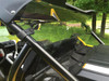 Extreme Metal Products clear rear window installed behind the cage of a yellow Yamaha YXZ, close side angle