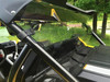 Extreme Metal Products clear rear window installed behind the cage of a yellow Yamaha YXZ, close side angle