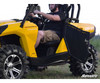 SuperATV black aluminum door swung open on a yellow Can-Am Commander with a driver seated, side view