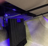 Sure Grip gas and brake guard installed in a vehicle footwell under blue interior lighting, angled view