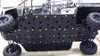 Trail Armor full skid plate with dimpled bolt pattern installed under a Polaris Ranger 800 Crew, side view in a shop