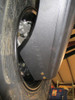 Close-up of the Trail Armor trailing arm guard at the Can-Am Maverick X3 rear hub with the part number stamped