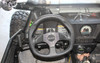 Sure Grip hand control lever mounted beside the steering wheel inside the cab of an Arctic Cat Wildcat, driver view