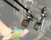 Close-up of Sure Grip push rods linked to the gas and brake pedals in the footwell with a driver foot in view