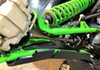 Close-up from below of the Trail Armor guard along the green lower A-arm of the Kawasaki Teryx KRX by the coil spring