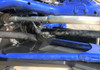 Underside view of the Trail Armor front arm guard on the blue Polaris RZR Pro XP lower A-arm beside the tie rod