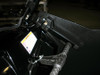 Close-up of the Trail Armor debris shield latch bracket and cable on the Polaris RZR door frame