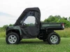 Side profile of the green John Deere Gator with the 3 Star full cab enclosure, door window and rear window visible