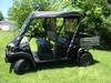 Driver side view of the Kawasaki Mule Trans with the 3 Star soft top and vinyl windshield installed
