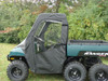 3 Star full cab enclosure with vinyl windshield and soft doors on a green six-wheel Polaris Ranger, side view on grass
