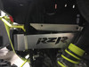 Universal Parts aluminum exhaust guard with RZR cutout installed on a Polaris RZR XP 1000, rear close-up