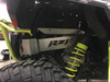 Rear view of a Polaris RZR XP 1000 with the Universal Parts exhaust guard, lime springs and rear tire