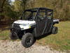 Side X Side soft doors with clear windows installed on a white Polaris Ranger Crew XP 1000, front three-quarter on gravel