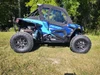Side X Side upper doors kit with soft cab installed on a blue Polaris RZR Turbo S, side view on grass