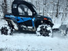 Side view of the blue CFMoto ZForce with Side X Side upper doors installed, pushing through deep snow