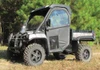Camo John Deere Gator XUV with Seizmik hinged doors closed, front three-quarter view among pine trees