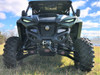 Trail Armor A-arm guards installed on the front lower arms of a green Yamaha Wolverine RMAX2, head-on view in a field