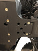 Close-up of the front skid plate section under the Wolverine RMAX2 showing bolt heads and drain holes