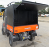 Wiedmann Bros 36-inch high black steel utility cap with rear door raised on an orange Kubota RTV X-Series bed