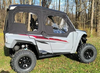 Side X Side full cab enclosure with doors and rear window on a gray Yamaha Wolverine RMAX4, side view on grass