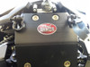 Close-up of the installed Trail Armor bash plate on a Yamaha Wolverine RMAX2 with a D-ring shackle and winch strap