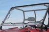 Seizmik folding windshield for the Bobcat 3400 in the upright position on the roll cage of a red side-by-side