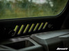 Close-up from inside the cab of the SuperATV glass windshield sliding vent slots and lock knobs above the dash