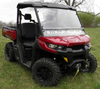 Front three-quarter view of a red Can-Am Defender HD8 with the 3 Star two-piece windshield and roof installed