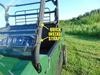 Close-up of the 3 Star half windshield quick install straps wrapped around a cage tube of a green side-by-side