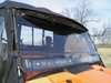 3 Star two-piece scratch-resistant windshield on an orange Honda Pioneer 1000 with a soft top, close-up from the front