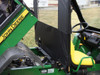 Side view of a John Deere Gator XUV with the 3 Star vinyl windshield and top, bed tilted up