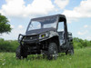 Front view of a camo John Deere Gator with the 3 Star vinyl windshield and black soft top, parked in tall grass
