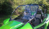 Extreme Metal Products clear DOT hard windshield installed on a green Arctic Cat Wildcat 1000, front three-quarter view