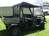 Passenger side view of the 3 Star soft top and rear window on a camo-bed Kawasaki Mule 3010 Trans