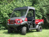 3 Star vinyl windshield, soft top and rear window on a red Kawasaki Mule 4010, front 3/4 view on grass