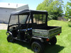 Rear three-quarter view of a Kawasaki Mule showing the 3 Star soft top and mesh rear window area