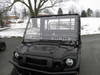 3 Star two-piece windshield installed on a black Kawasaki Mule Pro-FXT, front view with snow on the ground