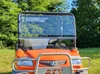 3 Star scratch-resistant 2-piece windshield on an orange Kubota RTV 900, front view in a field