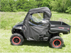 Side view of the black side-by-side with the 3 Star full cab enclosure doors zipped closed on grass