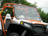 Front three-quarter view of the orange Polaris RZR 800 with the 3 Star one-piece windshield, trees behind