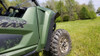 Rear three-quarter view of a green Yamaha Wolverine RMAX 4 with the Trail Armor fender extension behind the rear tire
