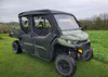 Front three-quarter view of a green Can-Am Defender Max with the 3 Star soft half doors and roof installed