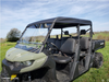 Passenger side view of the 3 Star soft top over the cab of a green Can-Am Defender Max with windshield