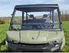 Front view of a green Can-Am Defender Max with the 3 Star soft top and a vented windshield on a grassy hill