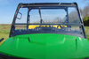 Close front view over the hood of the 3 Star two-piece windshield on a John Deere XUV 835/865, roof edge above
