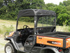 Rear three-quarter view of the orange Kubota RTV with the 3 Star vinyl top and windshield, cargo bed visible